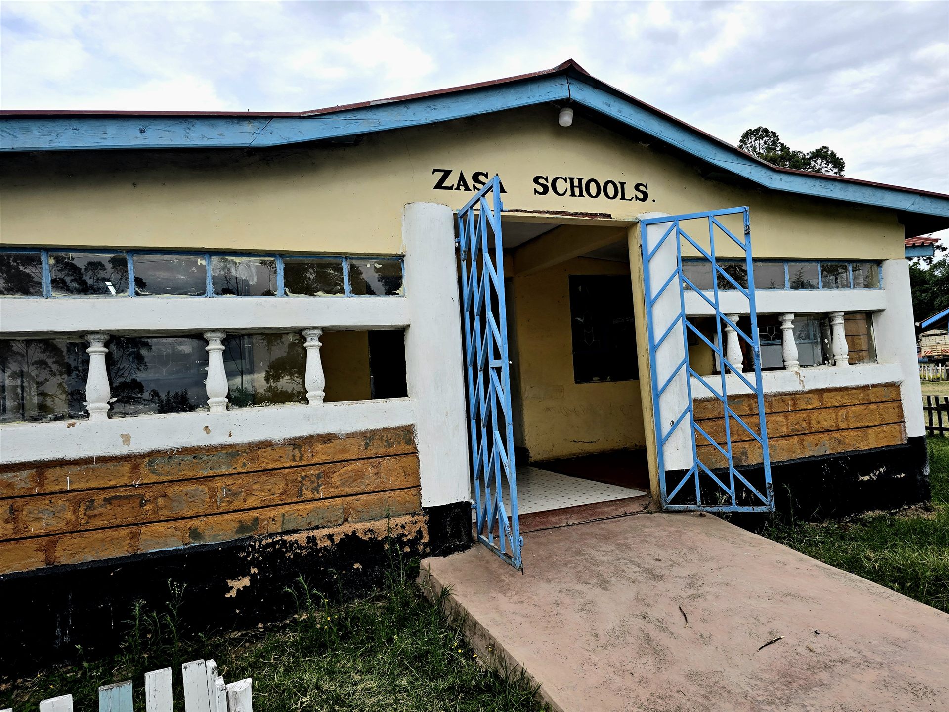 Entrance to Zasa Schools with the name painted above the door